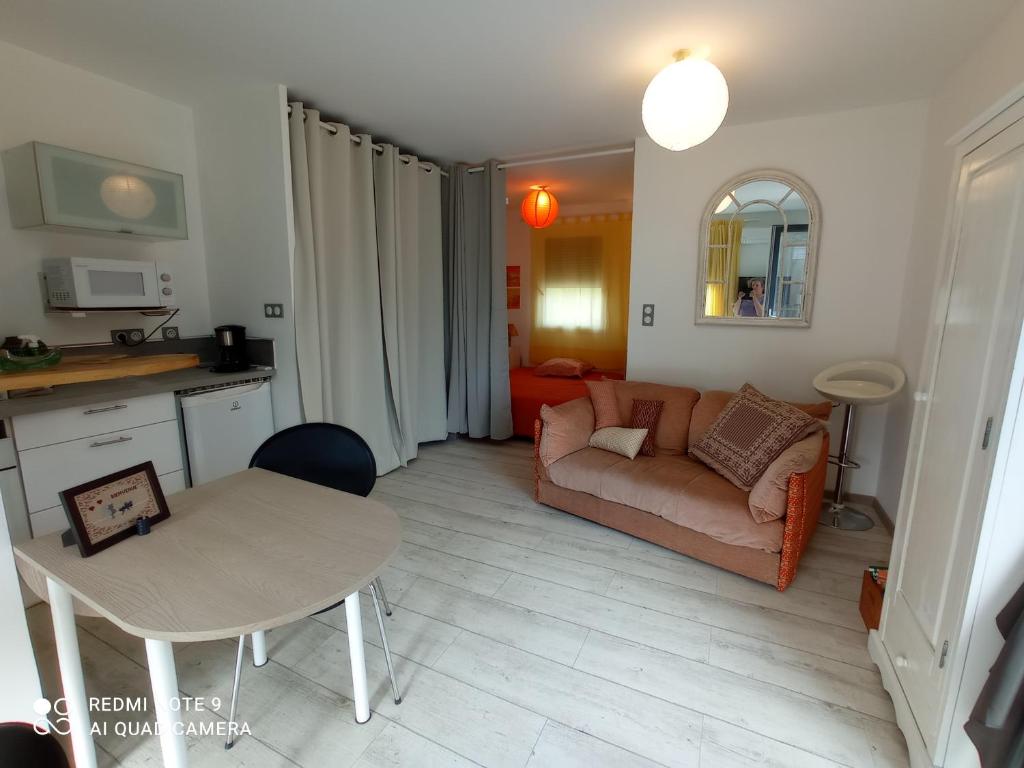 un salon avec un canapé et une table dans l'établissement Quietude, à Périgueux