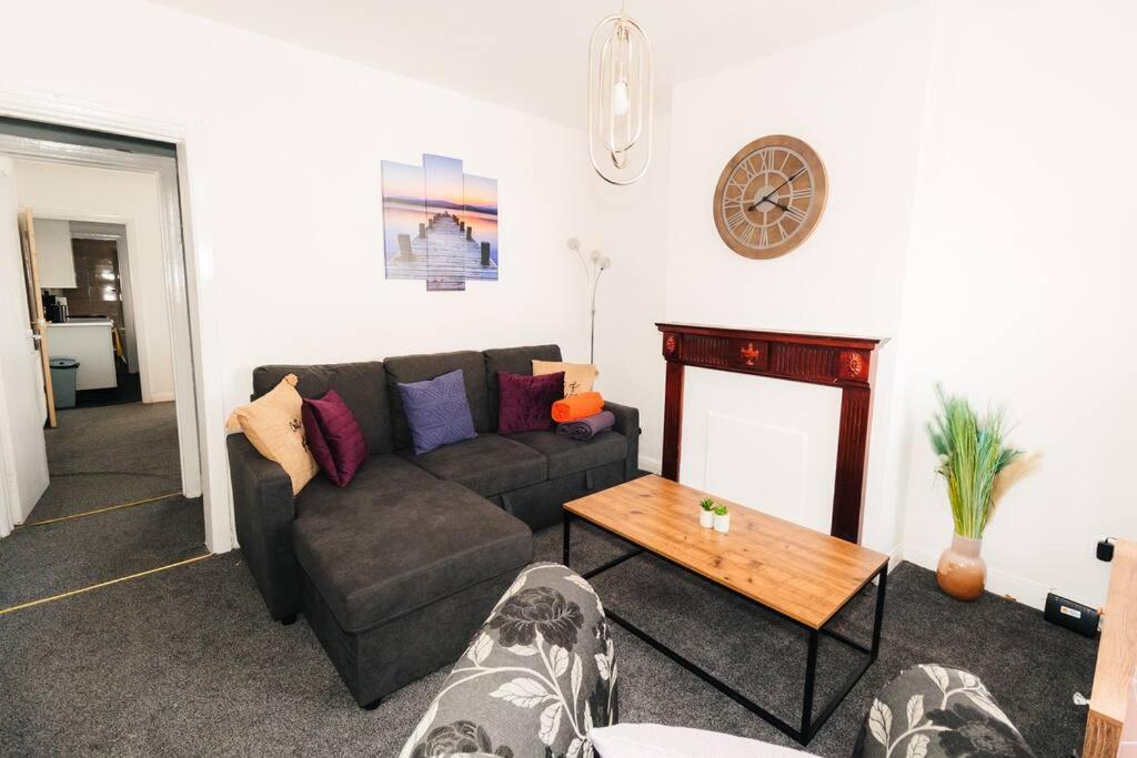 a living room with a couch and a table at Furnished Home in Birmingham in Birmingham