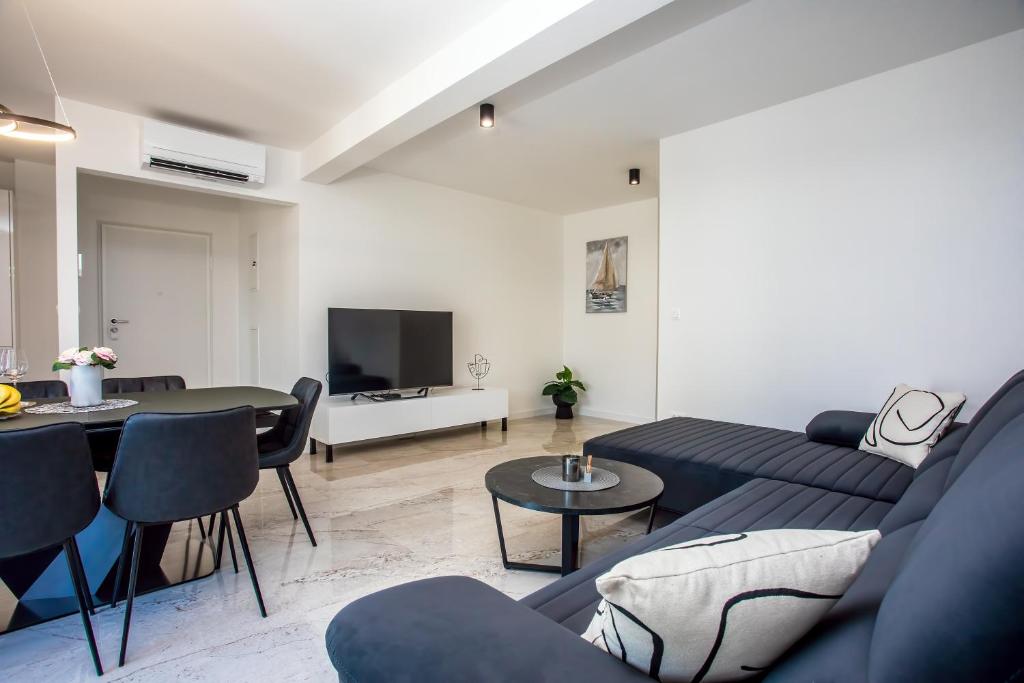 a living room with a couch and a table at Apartman sa prekrasnim pogledom,potpuno opremljen za 4 osobe in Podstrana