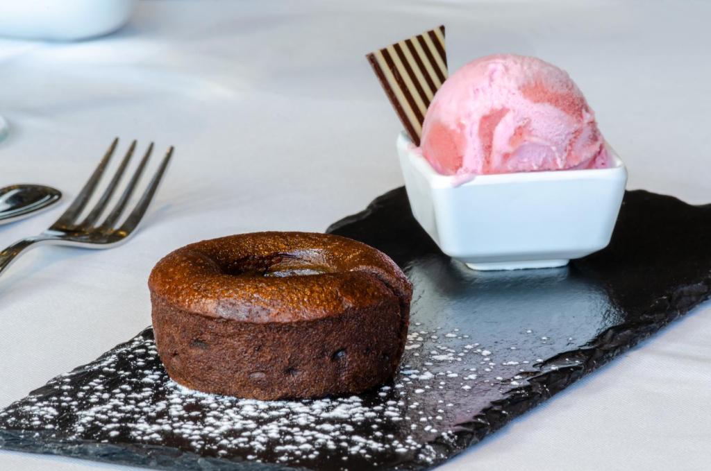 a chocolate cake and ice cream on a black plate at Olissippo Marquês de Sá in Lisbon
