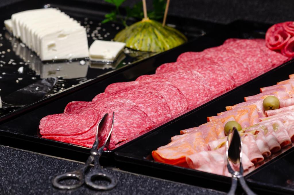 two trays of different types of meat and scissors at Olissippo Marquês de Sá in Lisbon