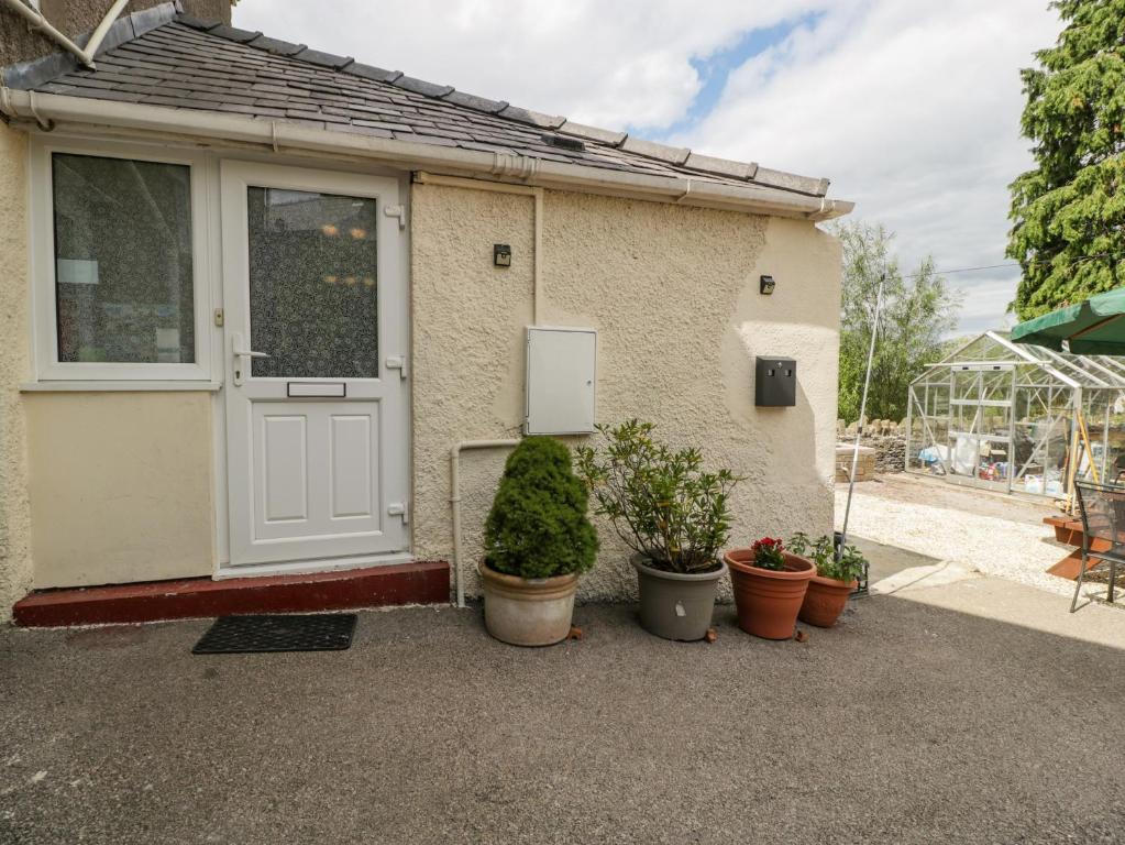 a house with potted plants in front of it at The Annexe in Lydney