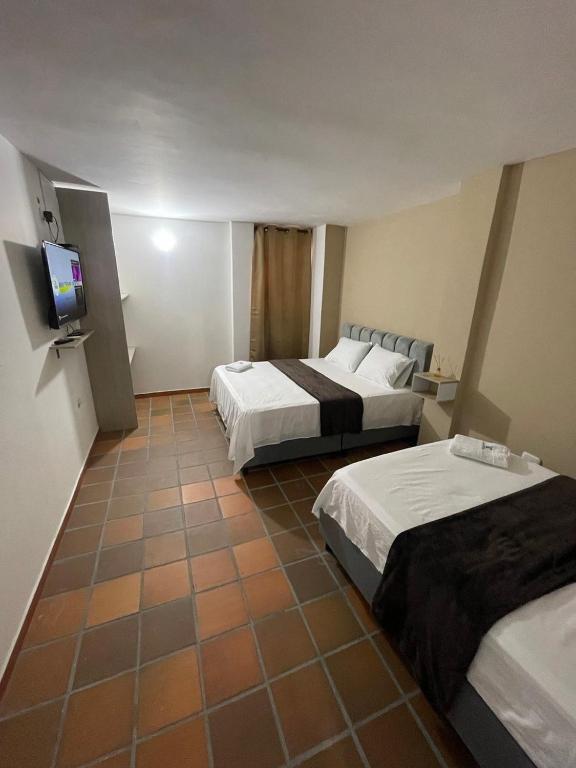 Postel nebo postele na pokoji v ubytování Hotel Valle Central