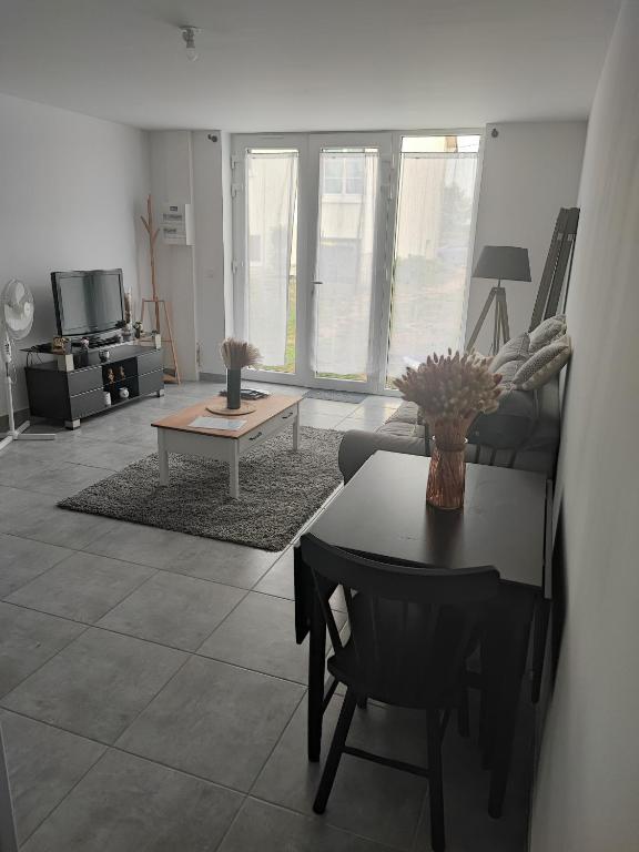 un salon avec une table et un canapé dans l'établissement Aux portes de Chambord, à Muides-sur-Loire