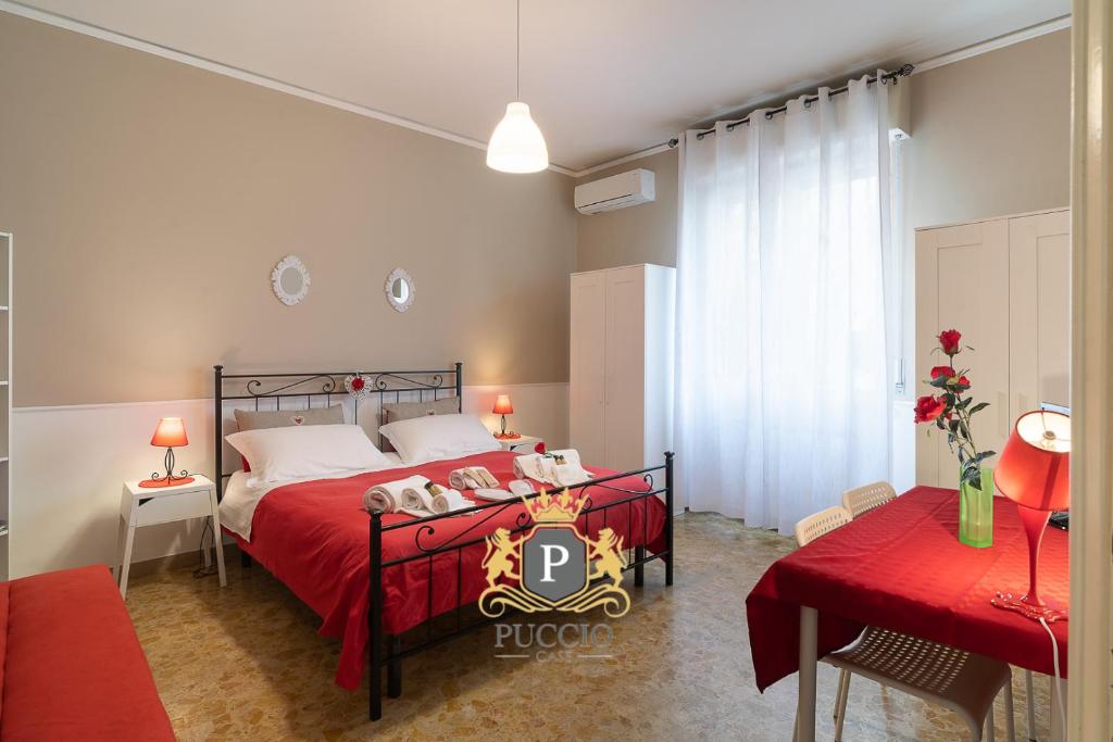 a bedroom with a bed with a red bedspread at Terrazze Italiane City Center - RED APARTMENT in Verona