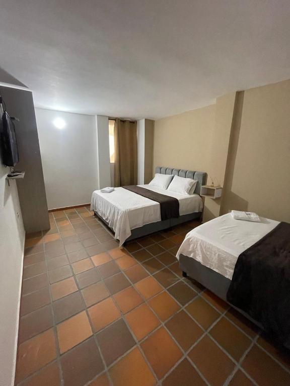 Postel nebo postele na pokoji v ubytování Hotel Valle Central