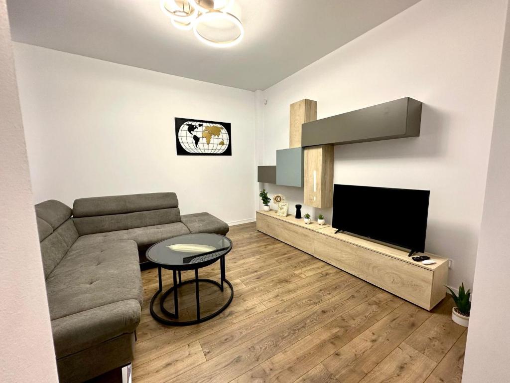 a living room with a couch and a television at XOX Villa House & Garden Bucharest in Bucharest