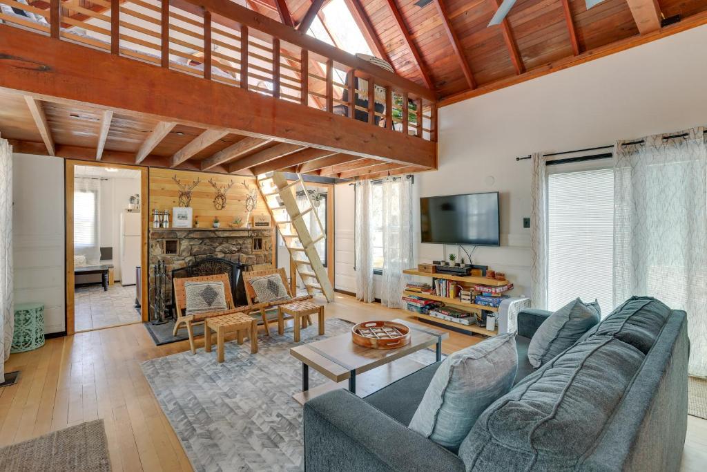 a living room with a couch and a fireplace at 2 Mi to Big Bear Lake Cabin with Game Room in Big Bear City