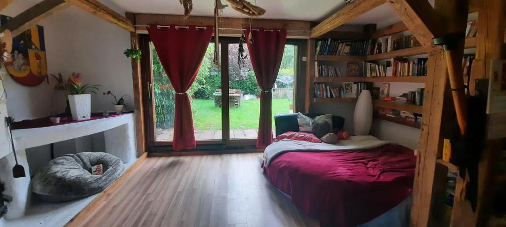a bedroom with a bed and a large window at Ferienhaus Feuer Wasser Luft Erde in Dobbrikow