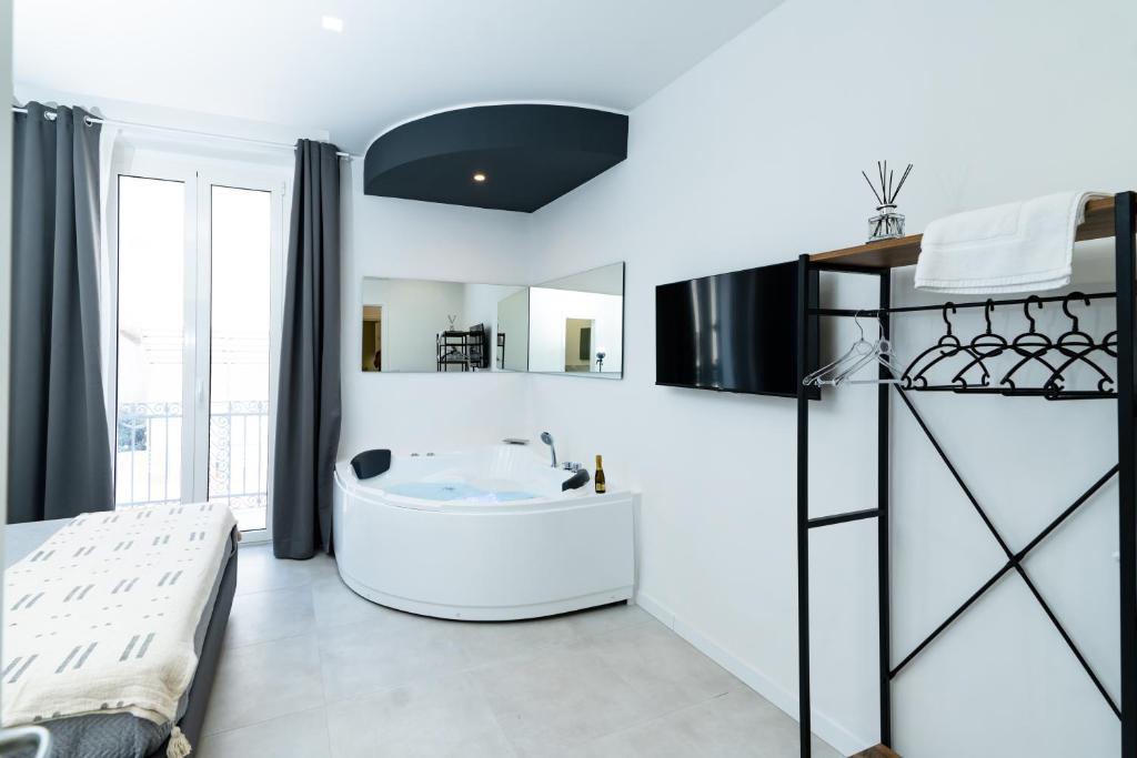 La salle de bains blanche est pourvue d'une baignoire et d'un lavabo. dans l'établissement Pane e Pomodoro, à Bari