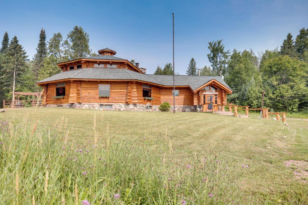 a log cabin with a large field in front of it at Ironwood Superior Home about 4 Mi to Big Powderhorn! in Ironwood