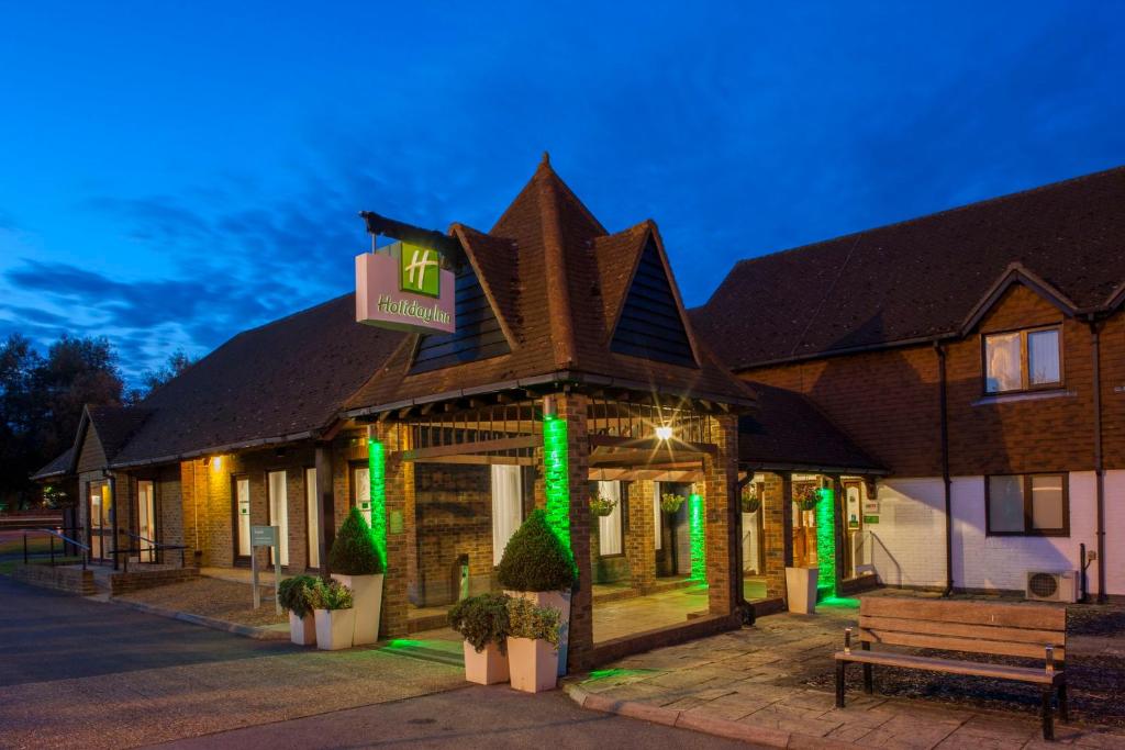 a building with green lights in front of it at Holiday Inn Ashford Central by IHG in Ashford