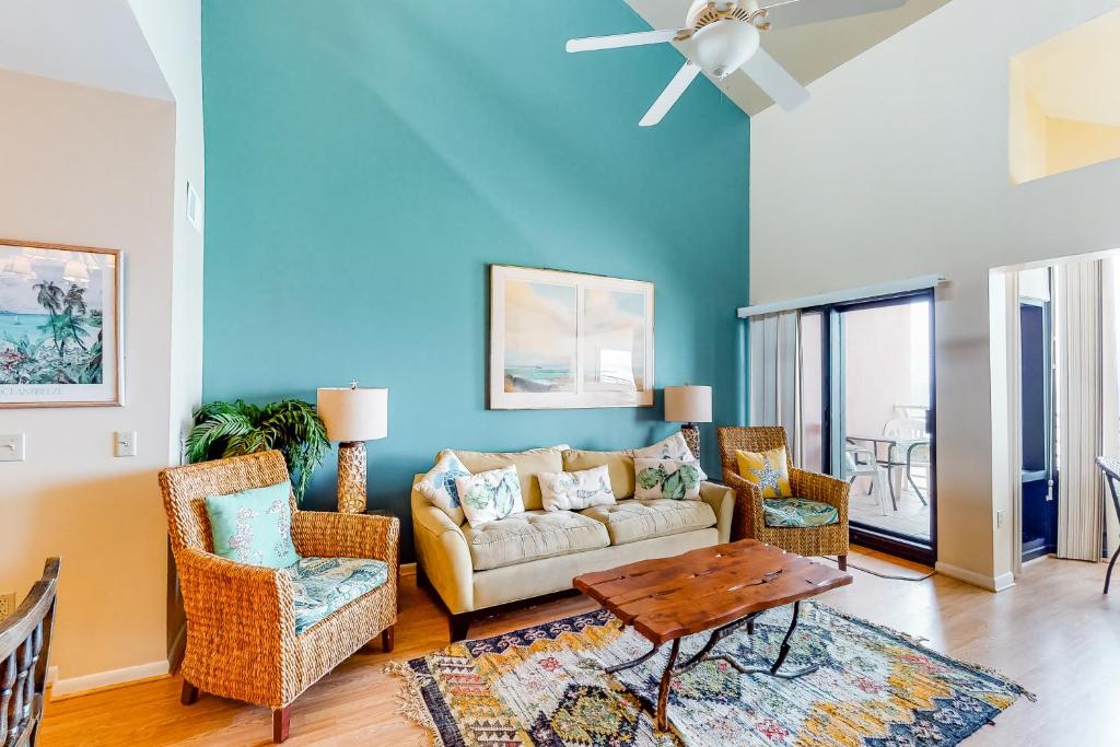 a living room with a couch and chairs and a table at Palm Beach Club 2-225 in Pensacola Beach