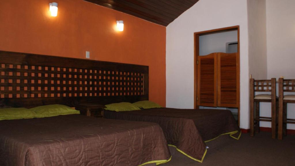 Postel nebo postele na pokoji v ubytování Hotel Chapala Country