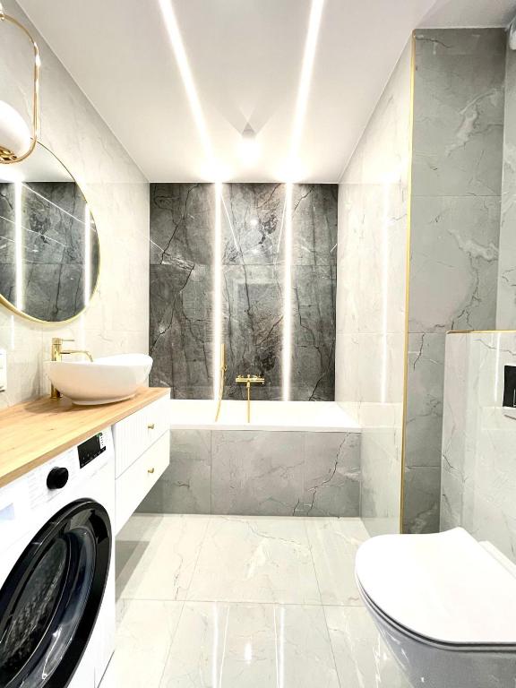 a bathroom with a sink and a washing machine at 3 Bedrooms Premium Bella Blue for 6 Guests with AC and Free out side Parking in Rzeszów