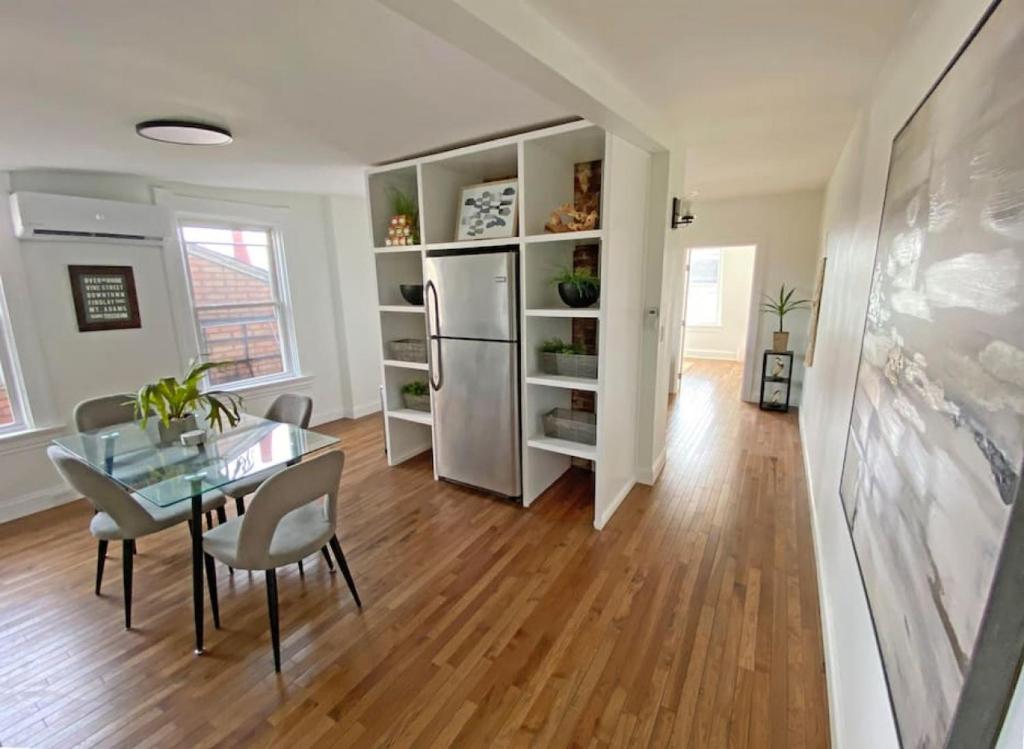 a kitchen and dining room with a table and a refrigerator at Explore Downtown and Mount Adams with River Views in Cincinnati