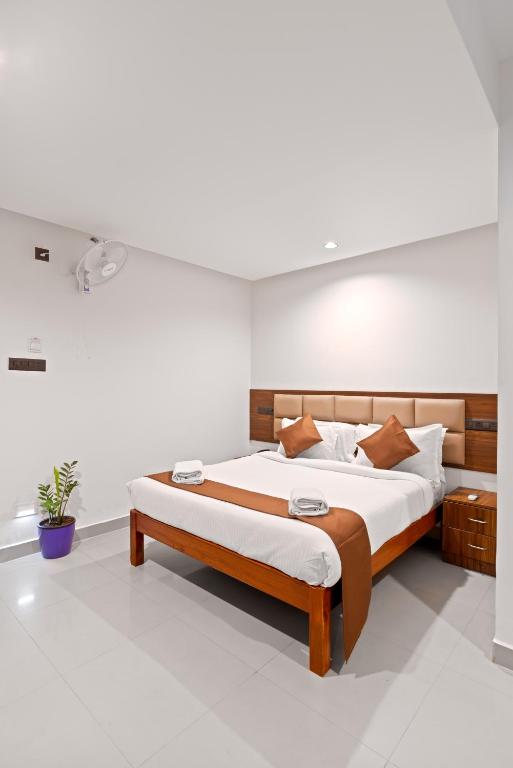 a bedroom with a large bed in a room at The Elite Hotel in Hyderabad