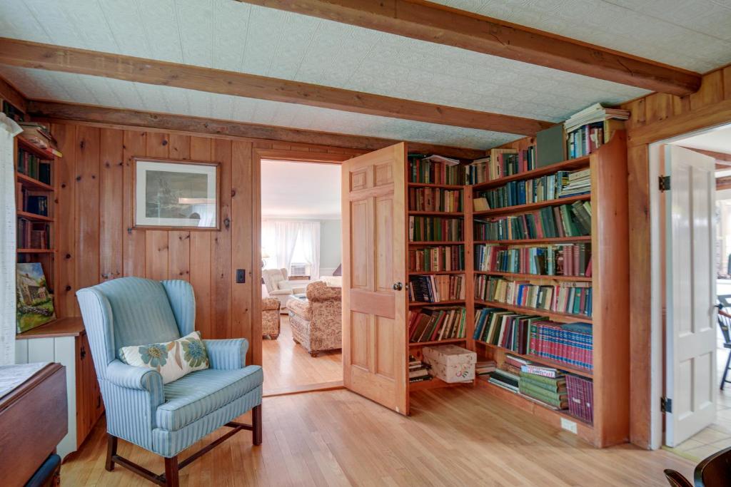 a living room with book shelves filled with books at Cozy Vacation Rental Home Near Lake Winnipesaukee! in Wolfeboro