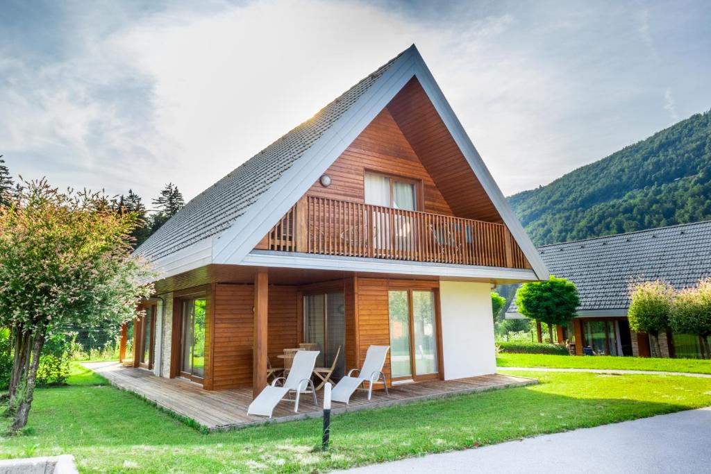 a wooden house with a gambrel roof at Apartment Rosemary in Topolšica