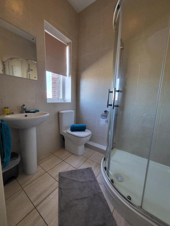 a bathroom with a sink and a toilet and a shower at The Jolly Sailor in Scalby