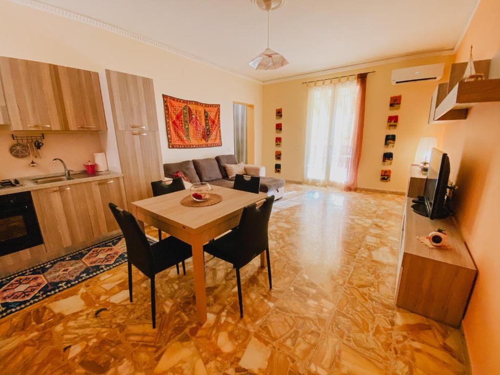 una cucina e un soggiorno con tavolo e sedie di Casa Vacanza Stella Maris a Isola delle Femmine