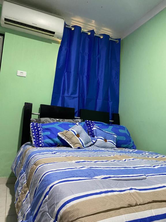 a blue bedroom with a bed with blue curtains at Hotel Napoles Valledupar in Valledupar