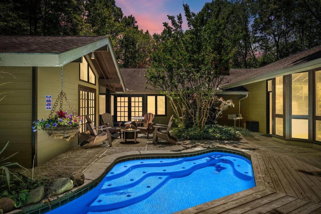 a swimming pool in the backyard of a house at Bourbon Hollow Lodge with Hot Tub and Pool plus Game Room only 5 min to downtown in Gatlinburg