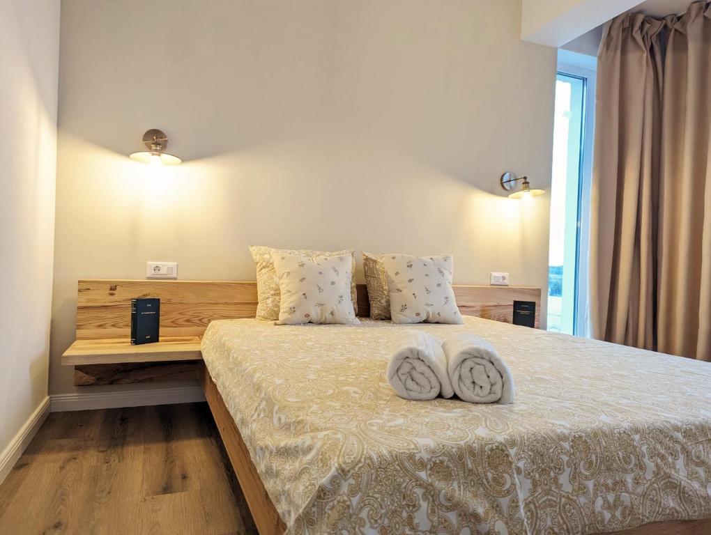 a bedroom with a bed with two pillows on it at La Bella Villa Mamaia in Mamaia Nord