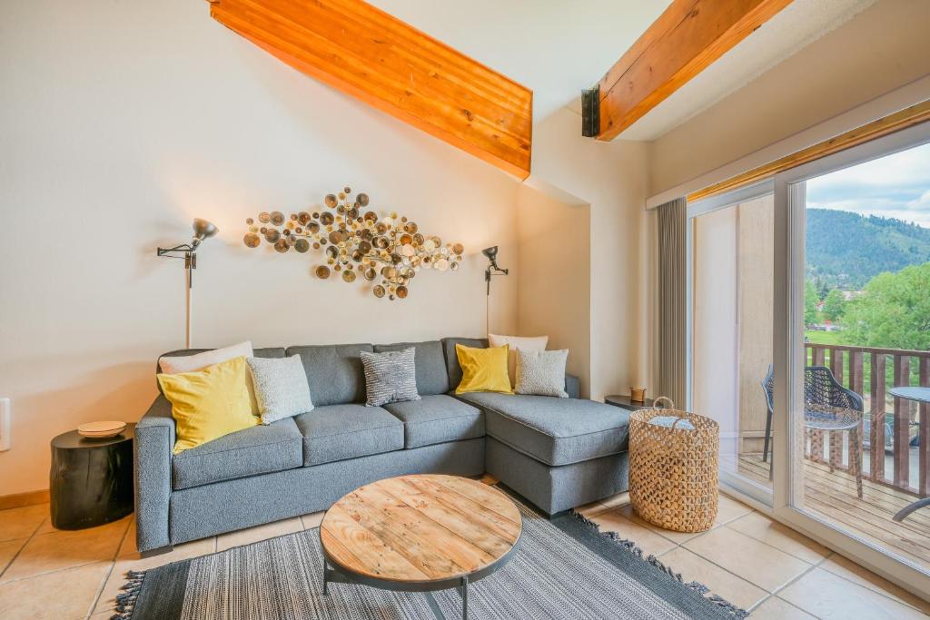 a living room with a couch and a table at Lift West #215 in Red River