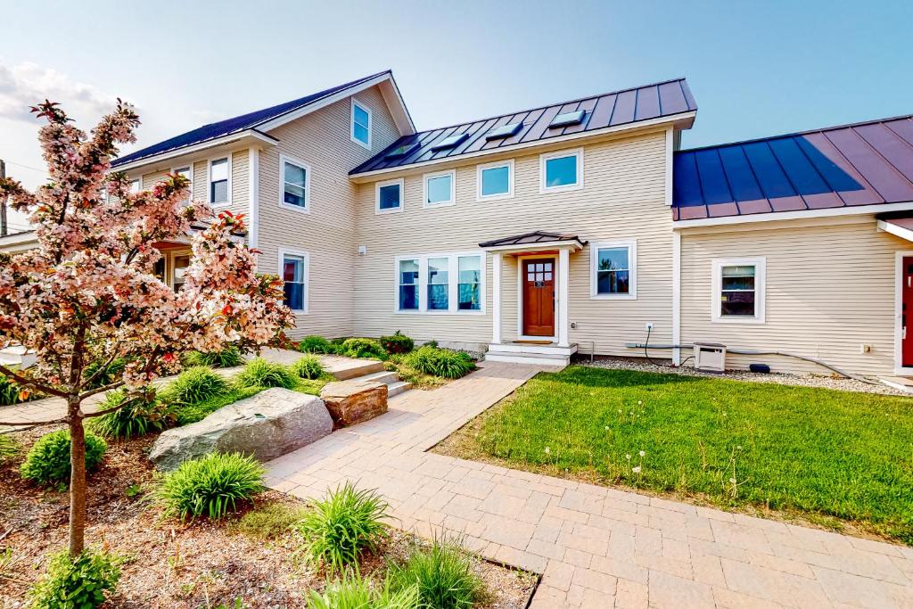 a house with solar panels on it at Waterbury-Stowe Farmhouse Units 1-3 in Waterbury