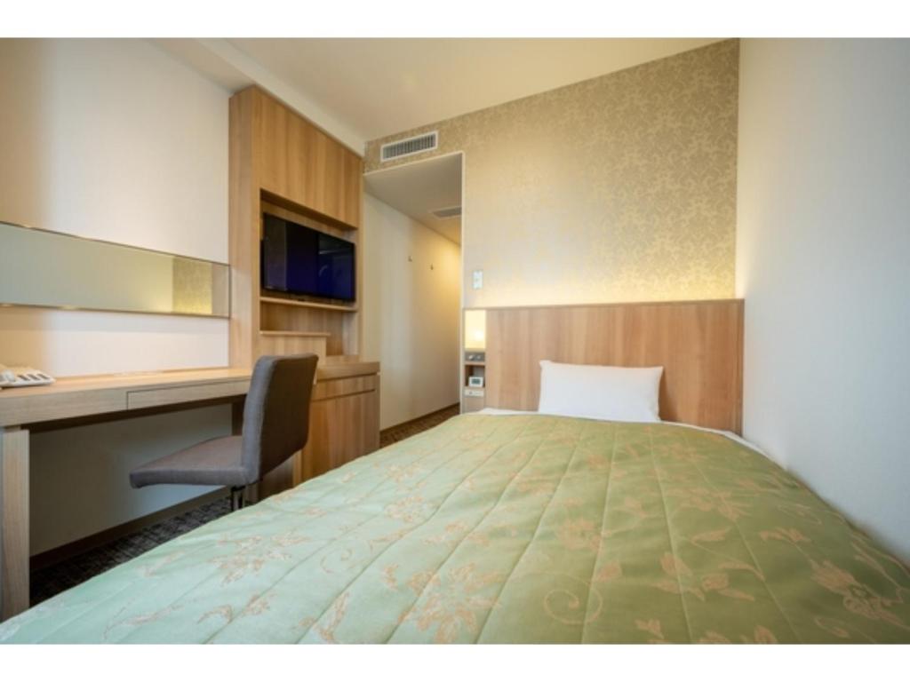 a hotel room with a bed and a desk at Misawa City Hotel - Vacation STAY 81780v in Misawa