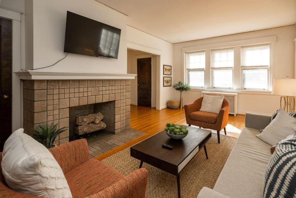 a living room with a couch and a fireplace at Hyde Park Comfort with Office Near Everything in Cincinnati