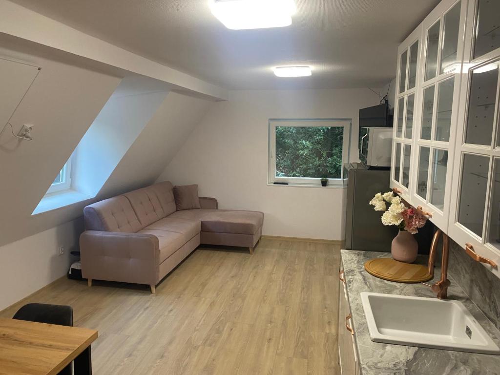 a living room with a couch and a table at Mega widok 2 in Szklarska Poręba
