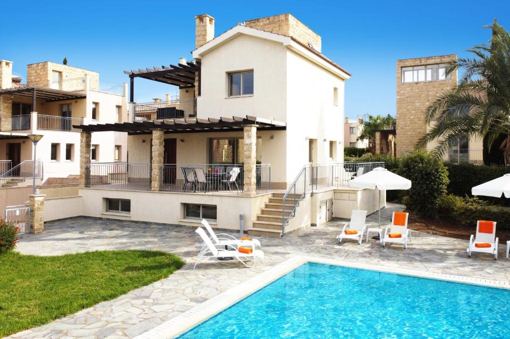 a villa with a swimming pool and a house at Villa Prosperity Limni by Villa Plus in Mavroli