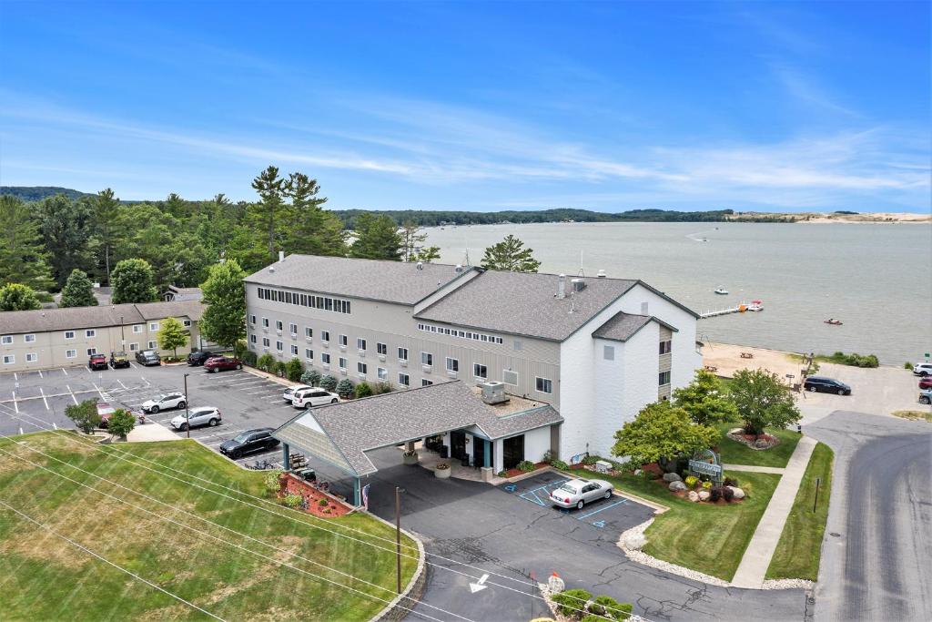 an aerial view of a large building with a parking lot at Dunes Waterfront Resort in Mears