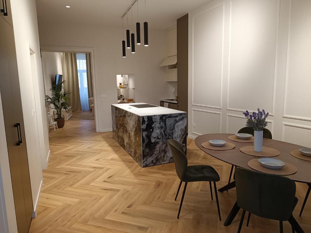 a kitchen and dining room with a table and chairs at MATE in Rijeka