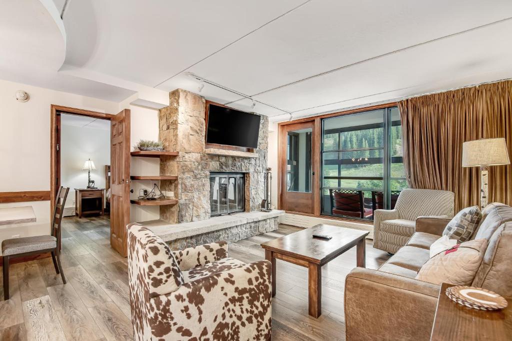 a living room with a couch and a fireplace at Mountain Plaza Base Camp in Copper Mountain