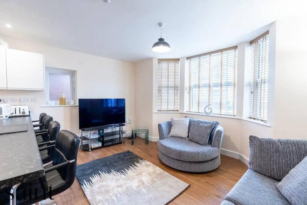 a living room with a couch and chairs and a tv at 2BR Apartment in Central Beeston with Parking in Nottingham