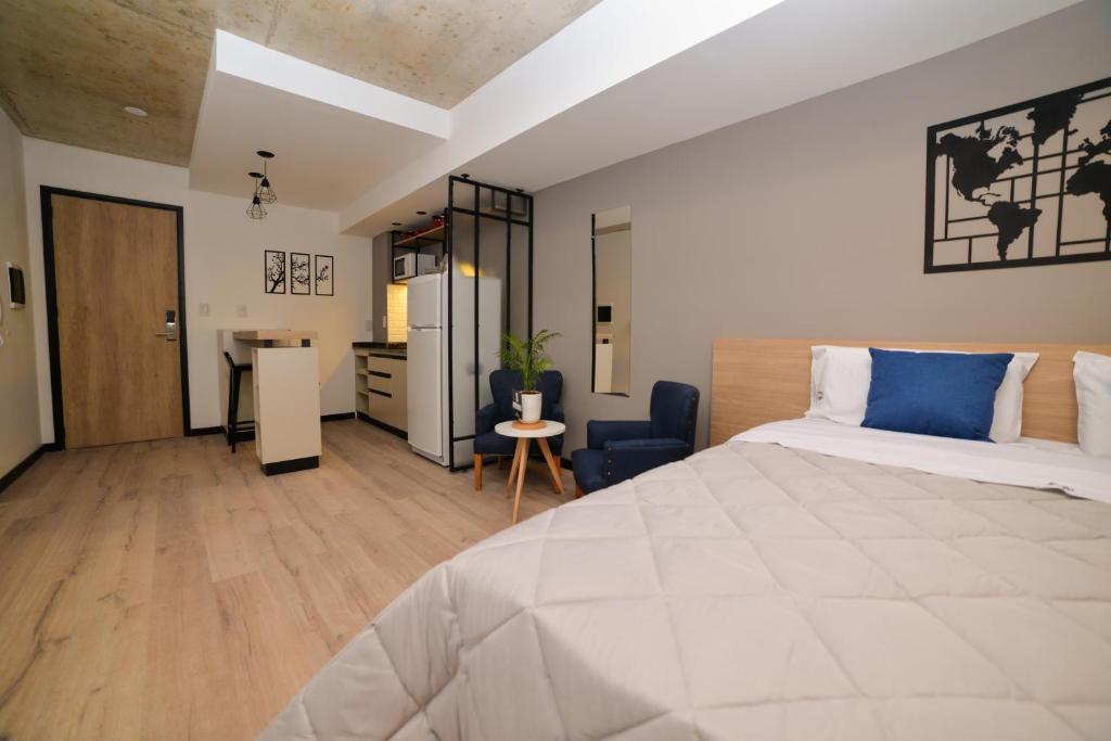 a bedroom with a large bed and a desk at Distrito A FMA-Coliving in Salta