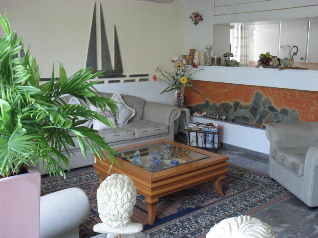 a living room with a couch and a coffee table at La Santre Villa in Amoudara Herakliou