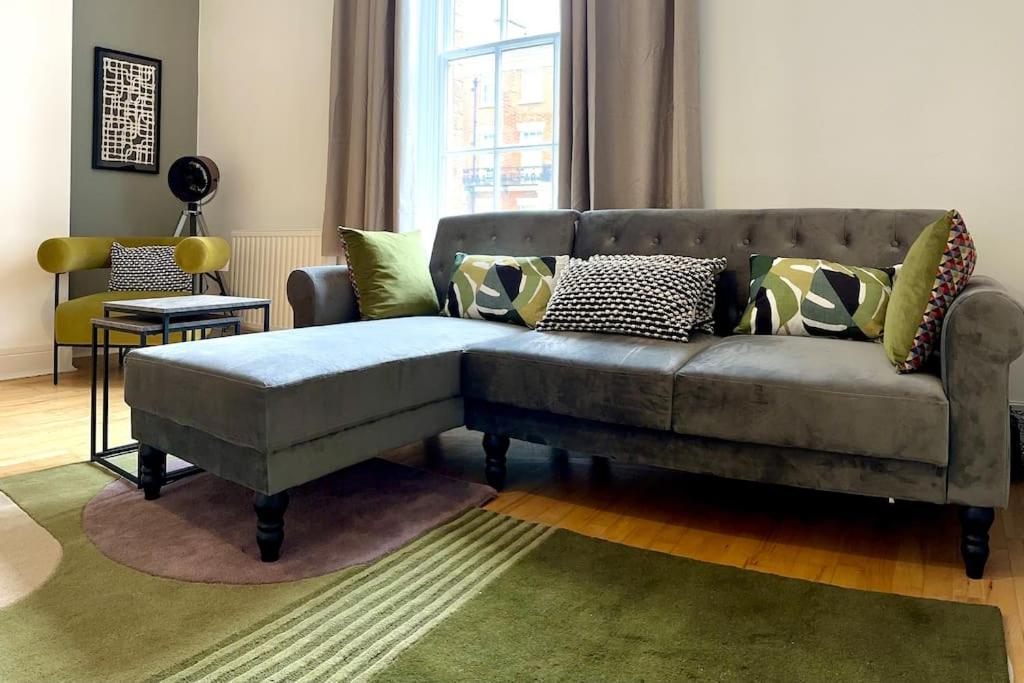 a living room with a couch with pillows on it at The Quirky Quarter- 2Bedrooms Apartment in Liverpool