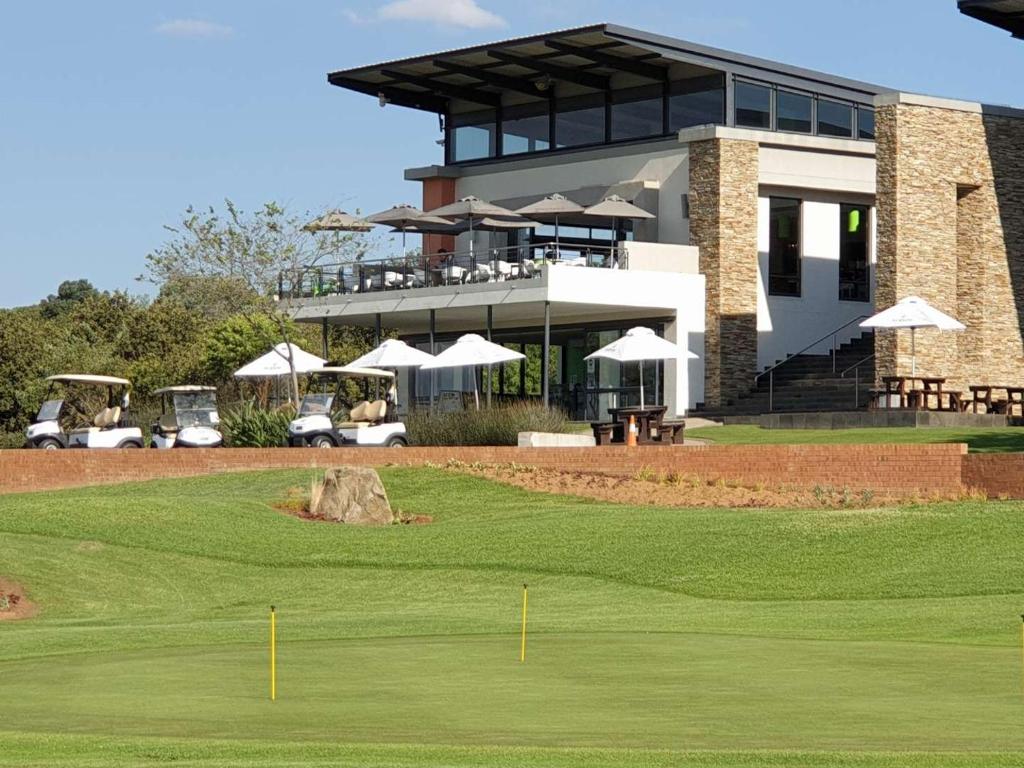 a view of a golf course with a building at Home far away from Home in Roodepoort
