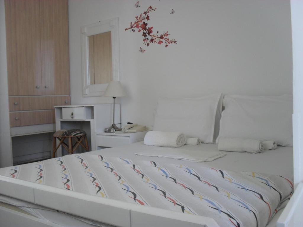 a white bedroom with a large bed in it at La Santre Villa in Amoudara Herakliou