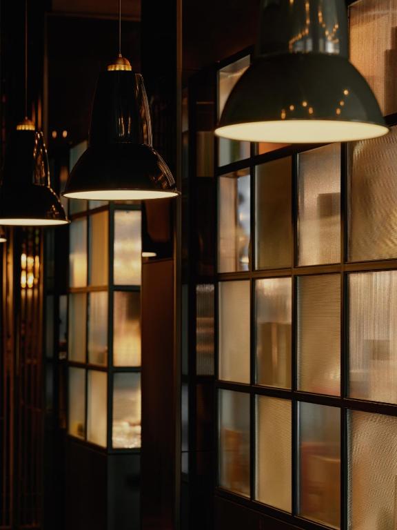 eine Gruppe von Lichtern in einem Raum mit Fenstern in der Unterkunft The Cloud One New York-Downtown, by the Motel One Group in New York