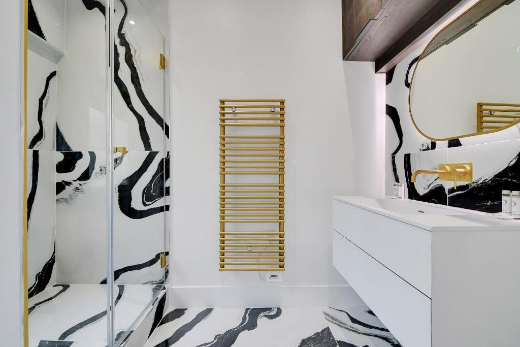 a bathroom with a sink and a mirror at Brand New Modern Studio in Central Paris - 2P - B6 in Paris