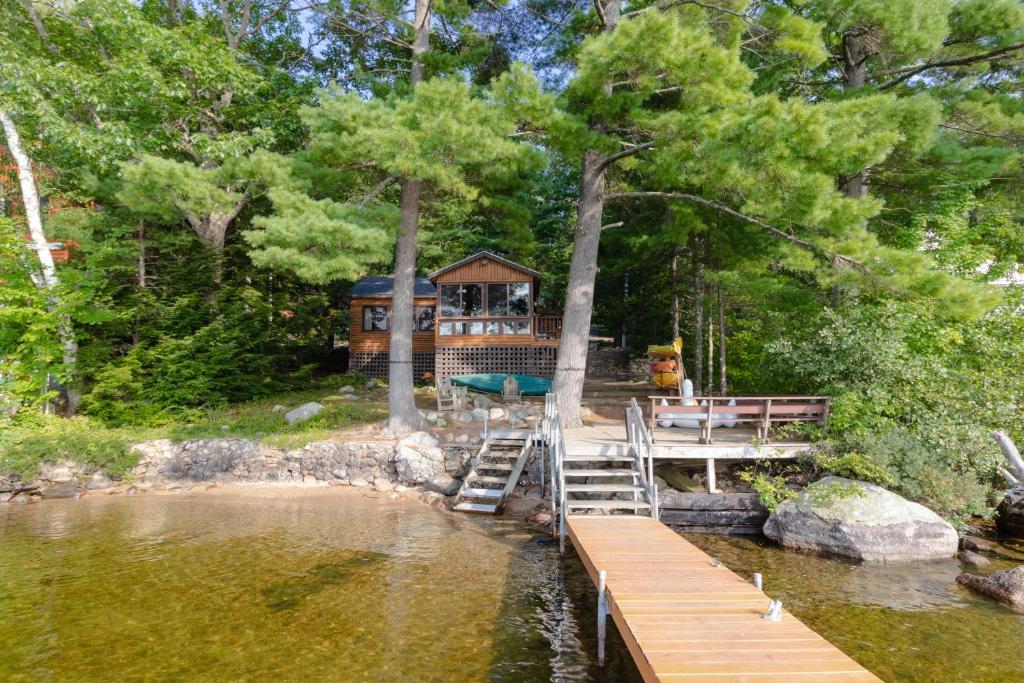 a house on the shore of a lake with a dock at Brandy Shores in Naples