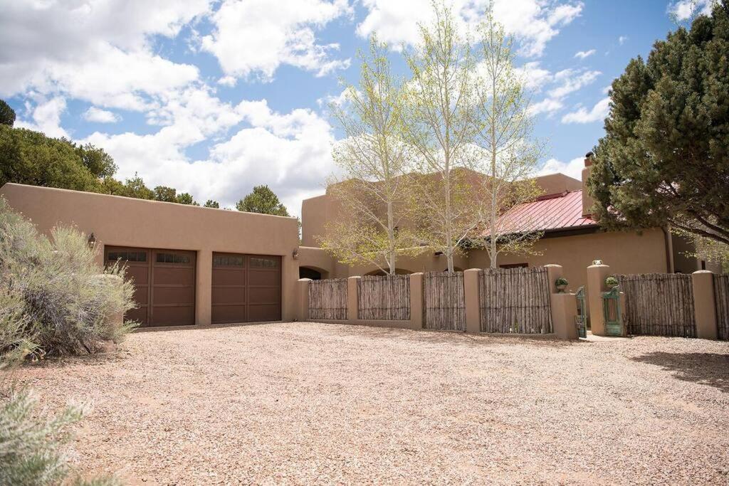 a house with a fence in front of a driveway at Sun and Ski! Beautiful, Downtown, on 1.5 Acres! in Santa Fe