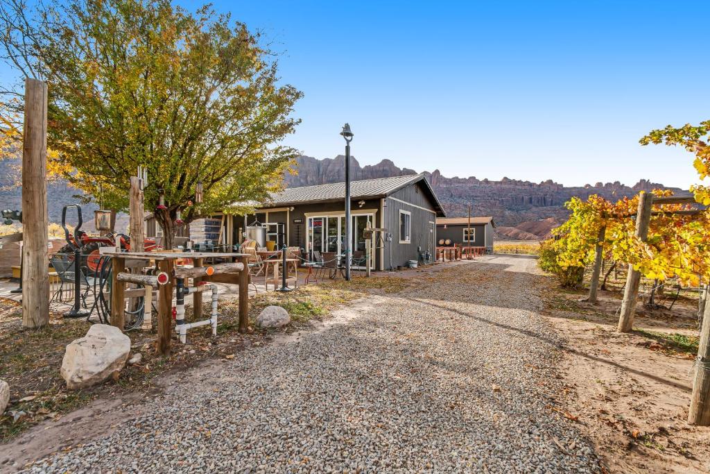 a gravel road in front of a building at Spanish Valley Vineyard - Both homes in Moab