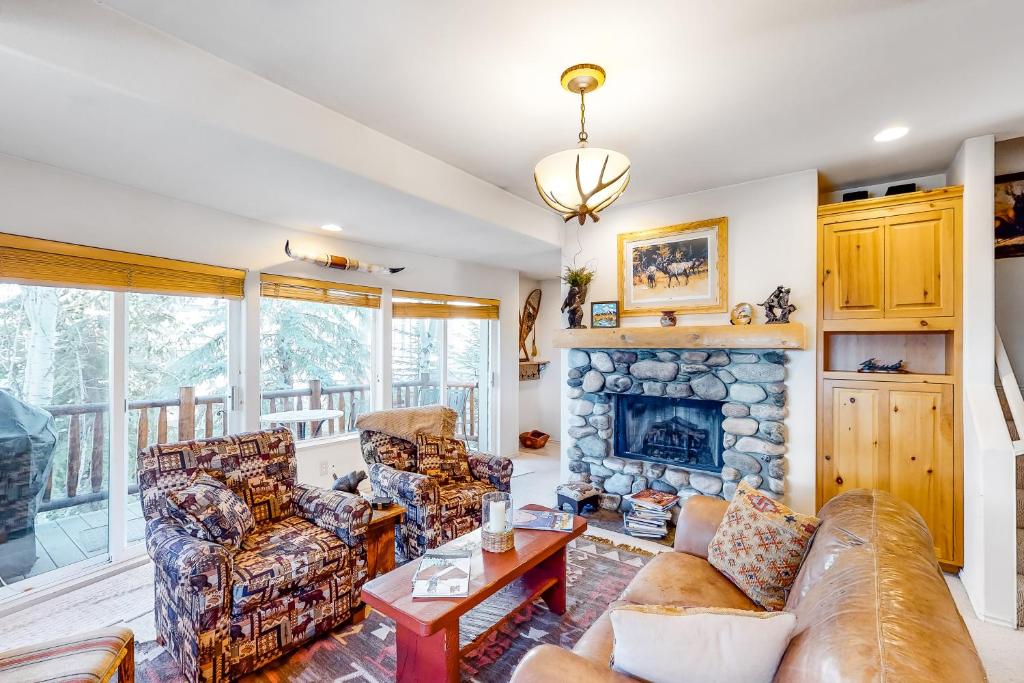 a living room with couches and a fireplace at Sun Bird Getaway at River Run in Ketchum