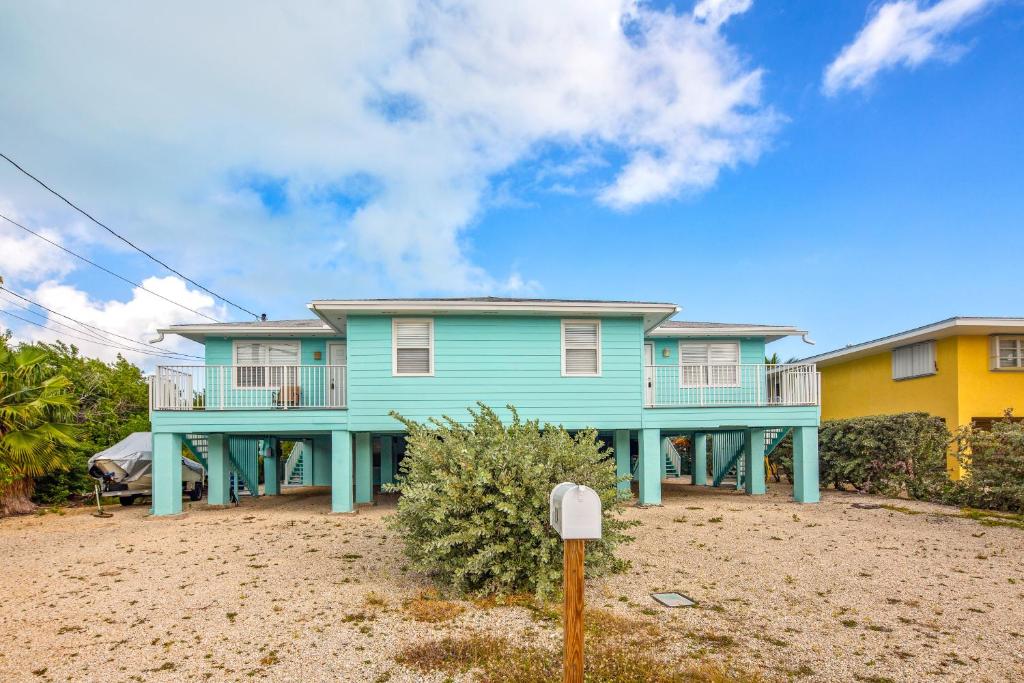 Casa azul con balcón en la playa en Lobster Lodge and Manatee Manor, en Duck Key